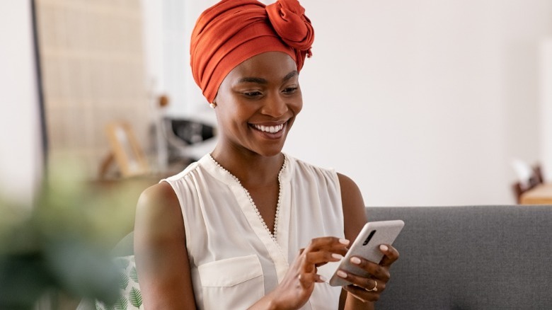 Woman smiling at her phone