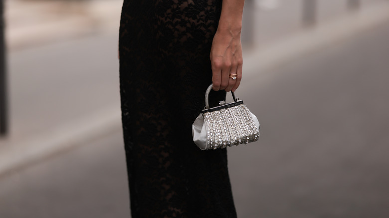 woman holding rhinestone bag