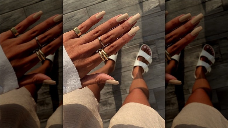 woman wearing chunky gold rings