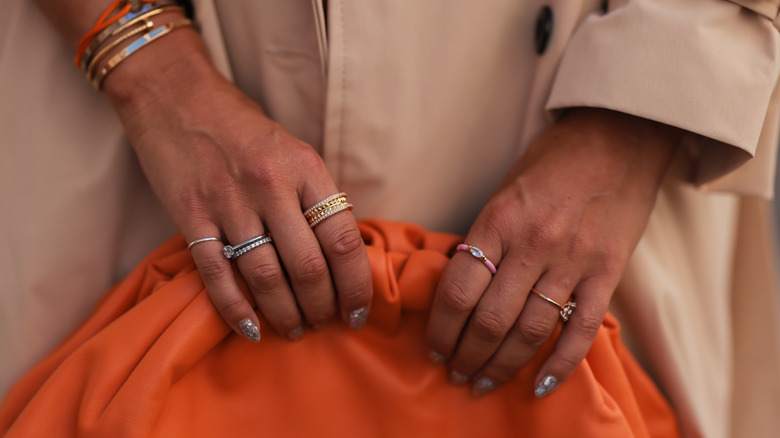 woman wearing mixed metals rings
