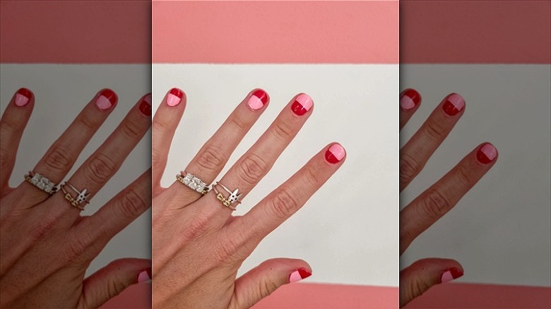woman wearing fashion rings on middle two fingers