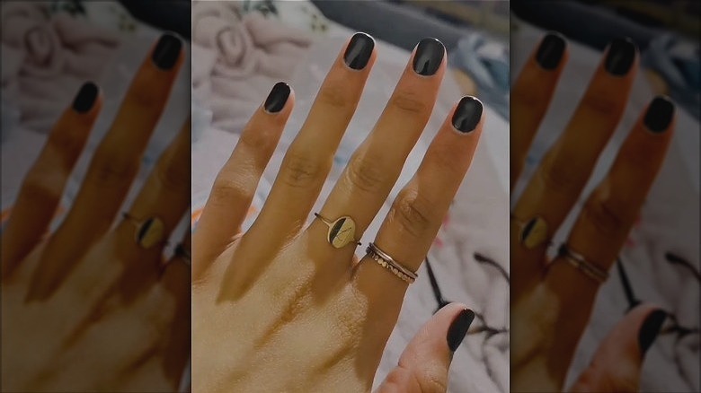 woman wearing thin gold rings