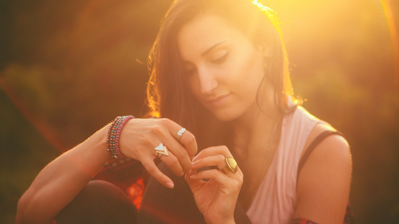 woman wearing chunky fashion rings