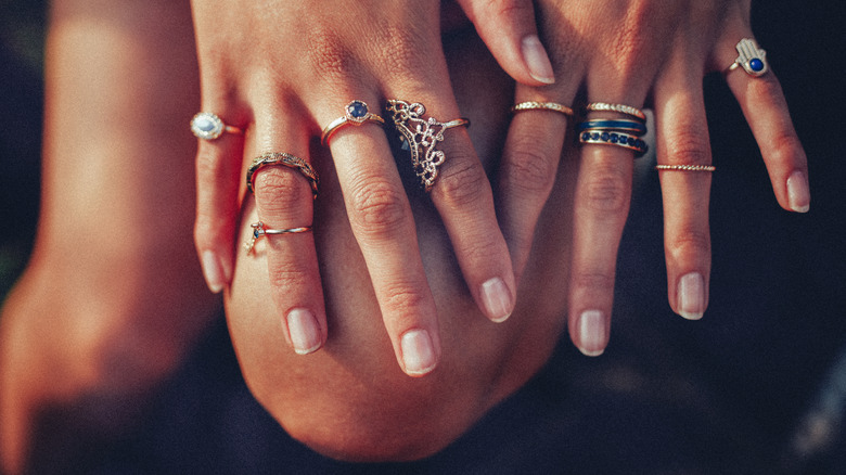 woman wearing lots of fashion rings