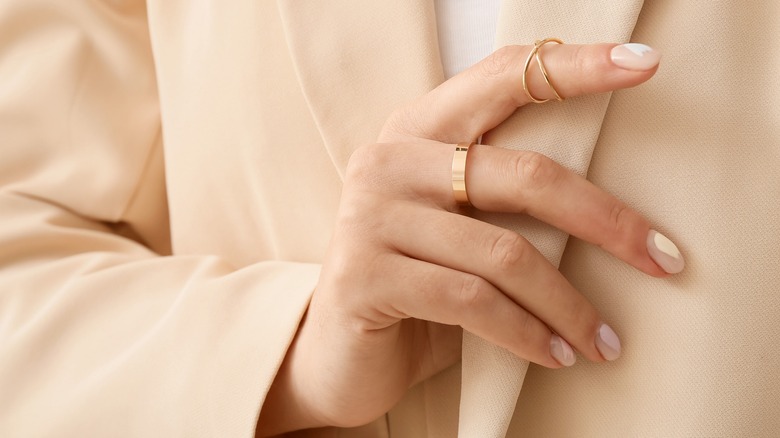 woman wearing gold ring on knuckles