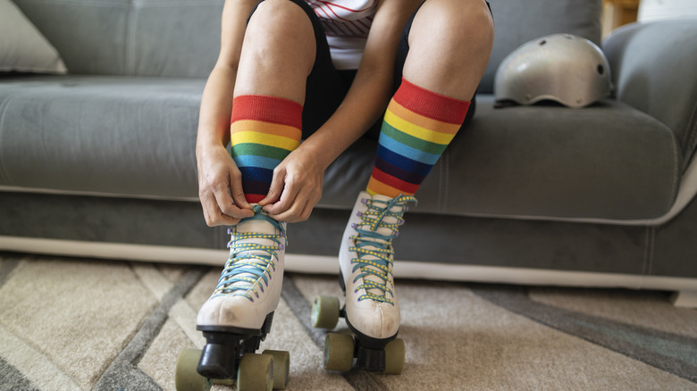 Woman laces up rollerskates