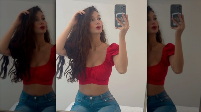 Red crop top with high-waisted jeans