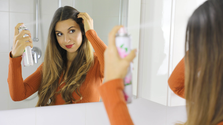 woman applying root spray 