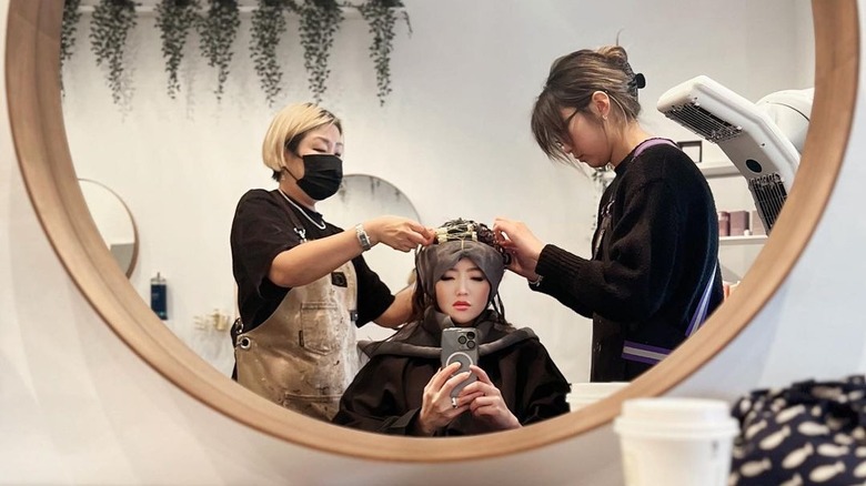 woman getting root perm