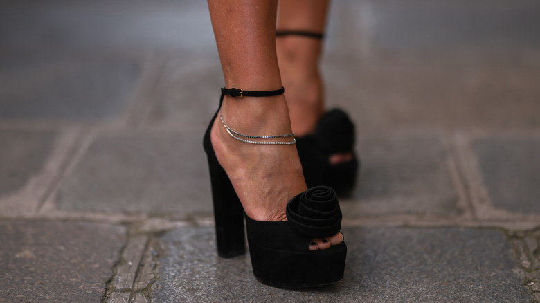 close up of rose black heels