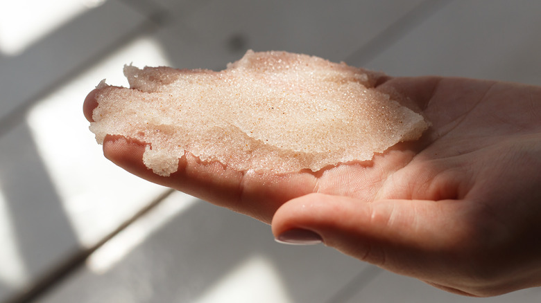 exfoliating scrub in hand