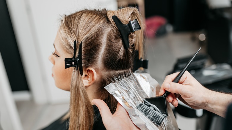 woman getting highlights at salon