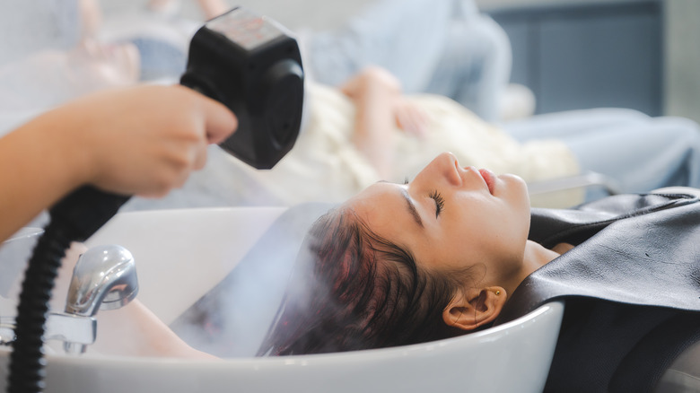 woman sleeping during hair wash