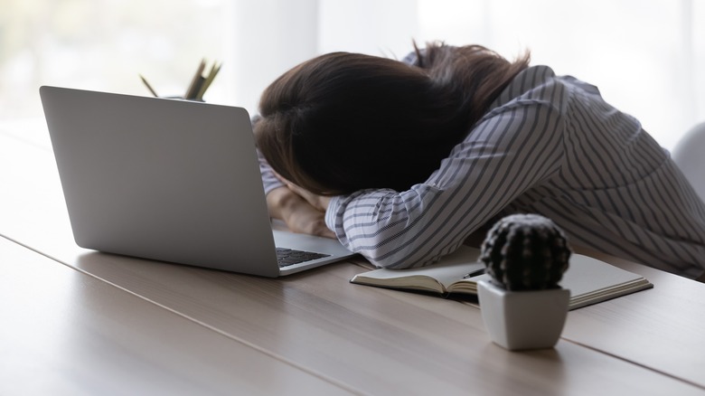 person sleeping at computer