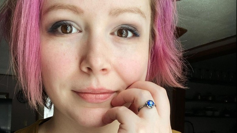 Girl wearing square-shaped sapphire ring 