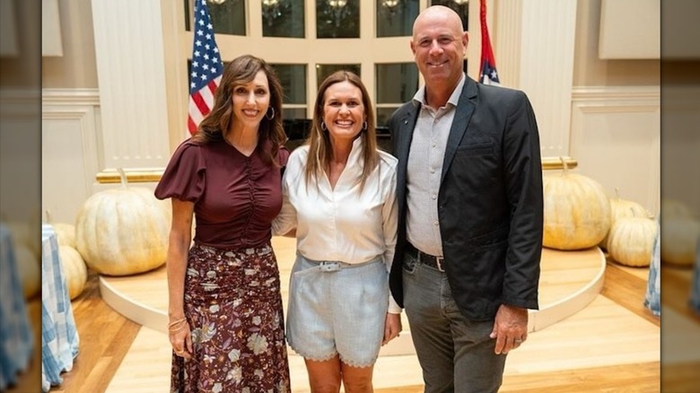 Sarah Huckabee Sanders posing with guests at the Governor's Mansion in Arkansas.