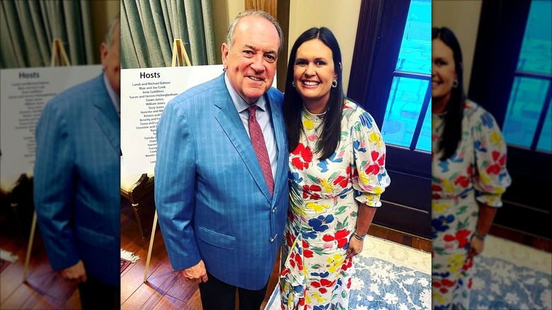 Sarah Huckabee Sanders poses with her father at an event.