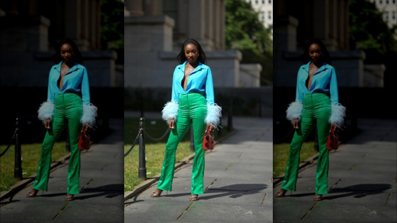 woman wearing green satin pants