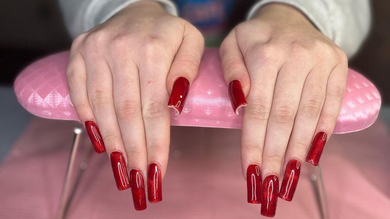 hands with red satin nails