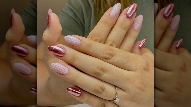 Hands with rose gold printed nails