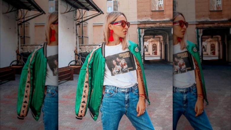 A woman wearing a satin bomber jacket