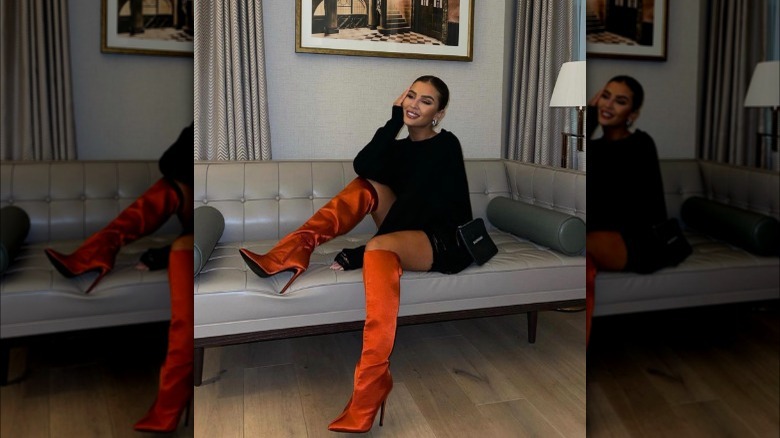 A woman wearing satin boots