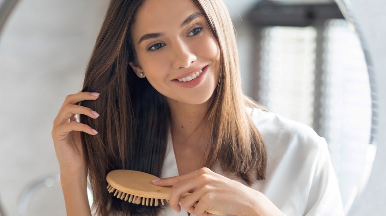 woman combs her hair