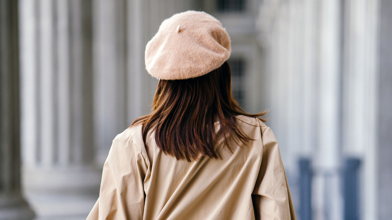 Woman wearing khaki jacket and beret