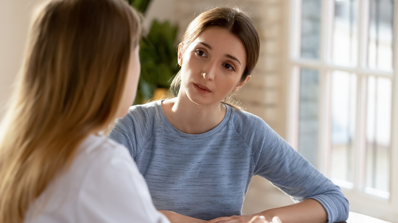 woman speaking with medical professional