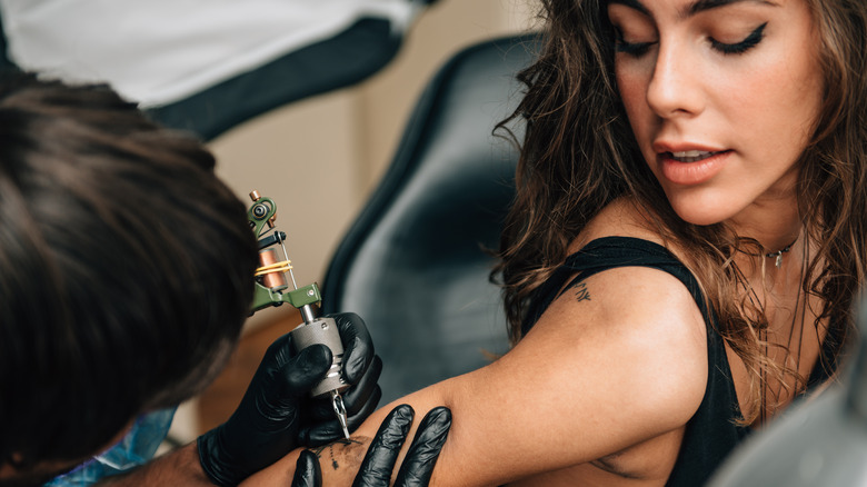 woman getting tattoo