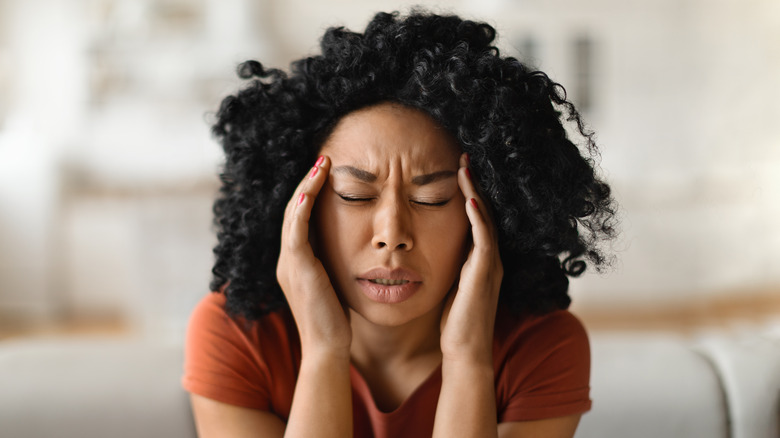 Woman with headache or migraine