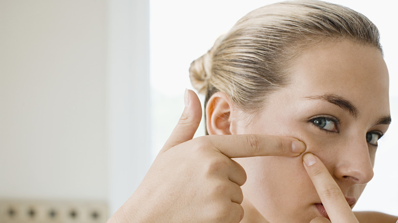 woman squeezing blackhead