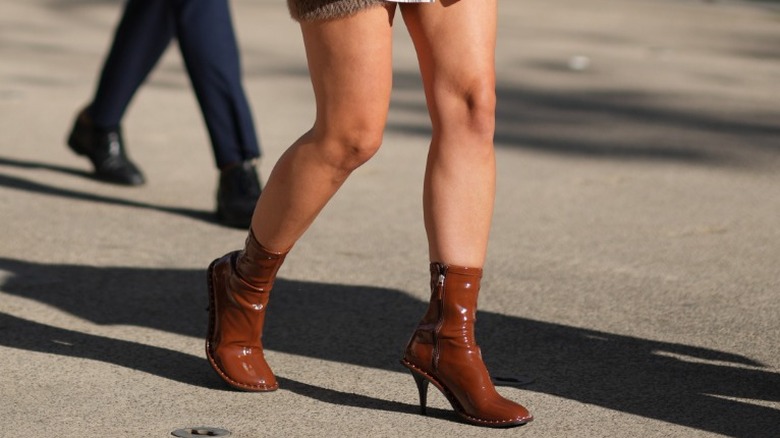 woman wearing brown ankle boots