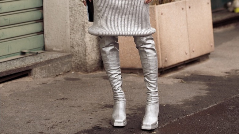woman wearing silver boots