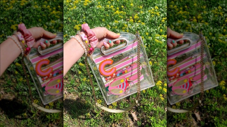 Person holding clear handbag