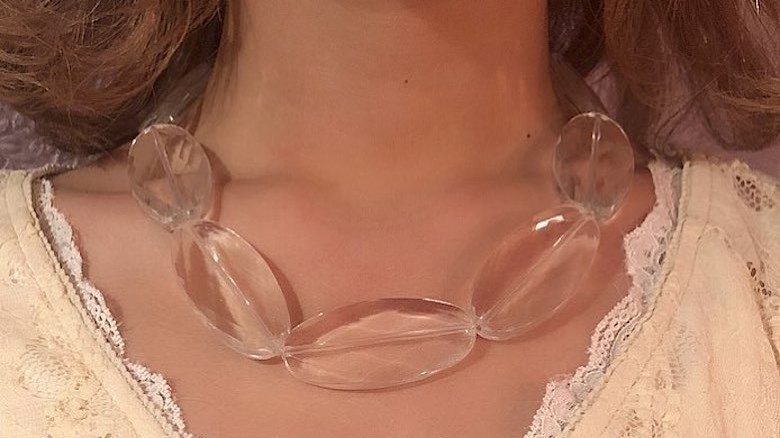 Person wearing chunky clear necklace