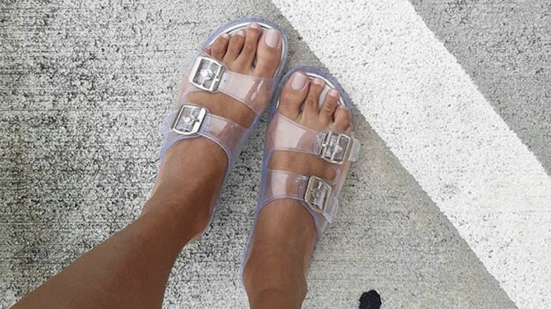 Feet in clear sandals