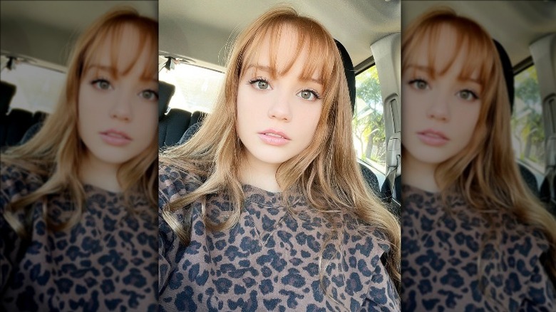 woman with bouncy red hair and bangs