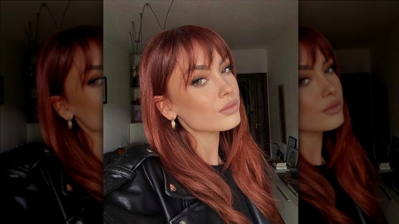 woman with deep red see-through bangs