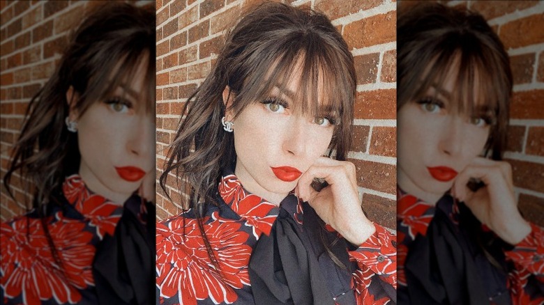 woman with bangs and floral print top