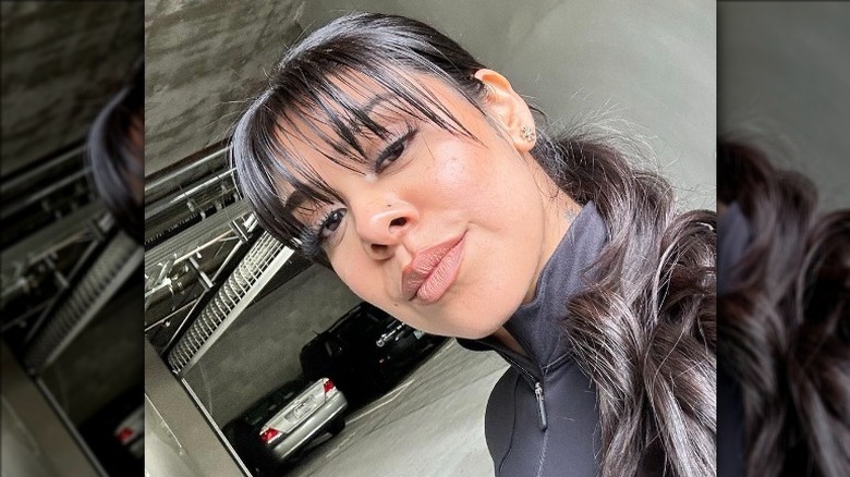 woman with see-through bangs with a low ponytail