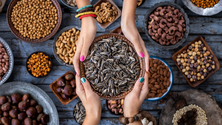 Holding bowl of sunflower seeds