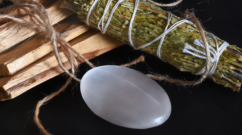 polished selenite stone with sage stick