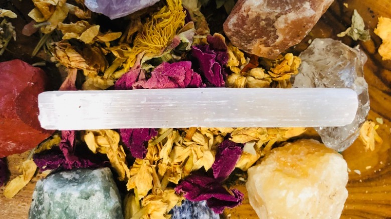 selenite wand with dried flower petals