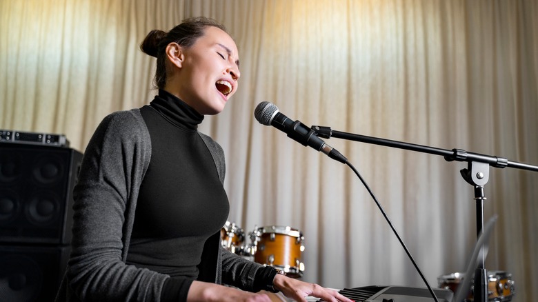 Girl singing and playing the piano