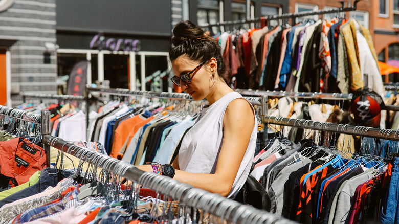 Woman shopping outdoor clothing racks