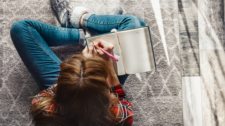 Woman writing in a journal