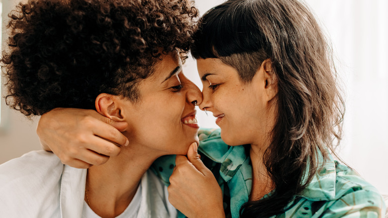 A lesbian couple smiling