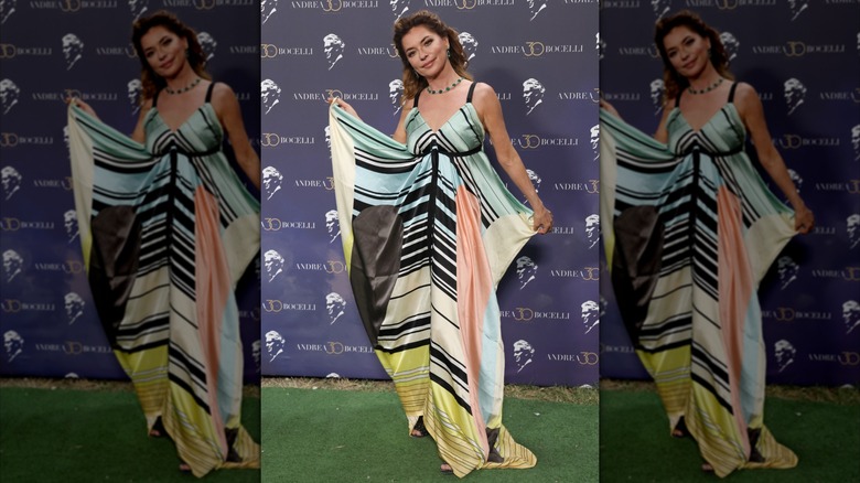 Shania Twain wearing a striped spaghetti-strap kaftan on the red carpet.