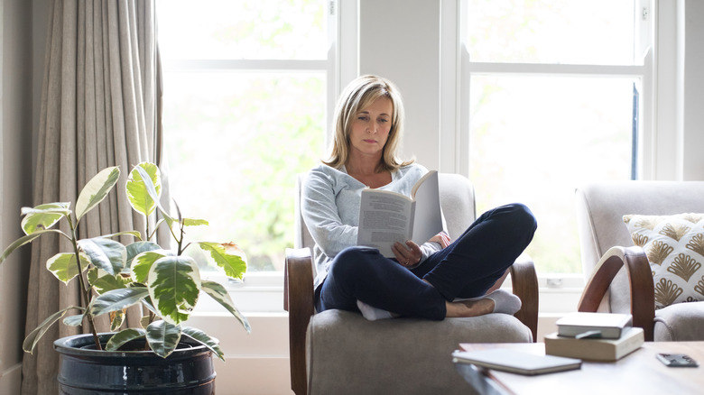 Woman resting in comfortable clothes by window